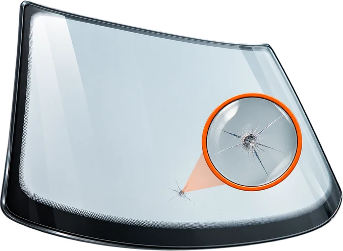 Illustration of a windscreen chip with a magnified detail
