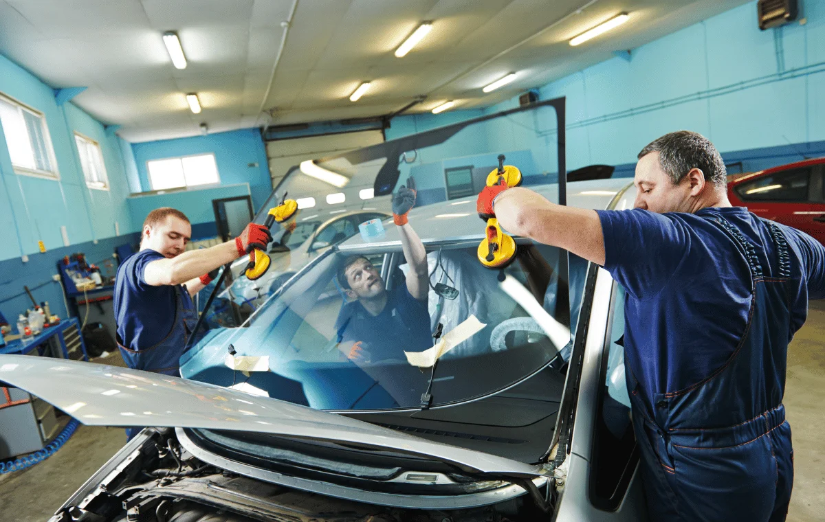 Technicians fitting a replacement windscreen